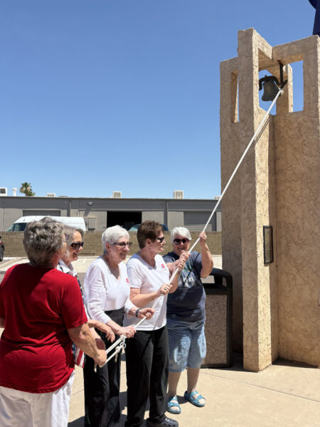 Members ringing the Freedom Bell at the William Bloys American Legion Post 2, Tempe, on July 4. The brass bell was used during WW II in an Austrian concentration camp and is rung only on the 4th of July.